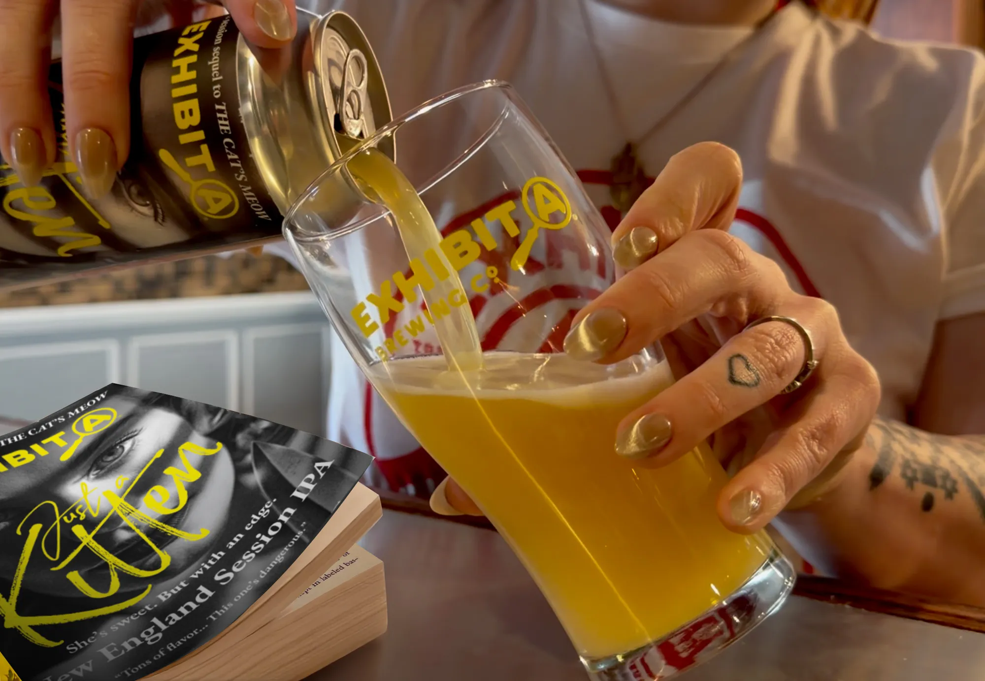 Pouring an Exhibit A beer from the can into a branded pint glass at the taproom