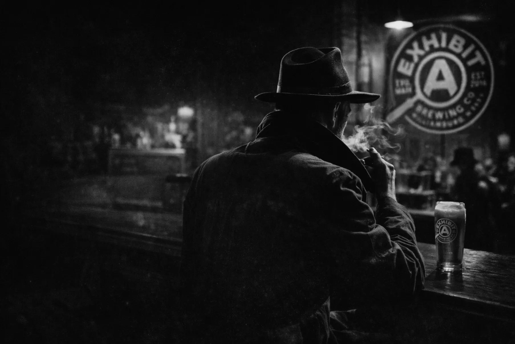 Noir detective, smoking in a darkly lit bar with a glass of Exhibit A beer