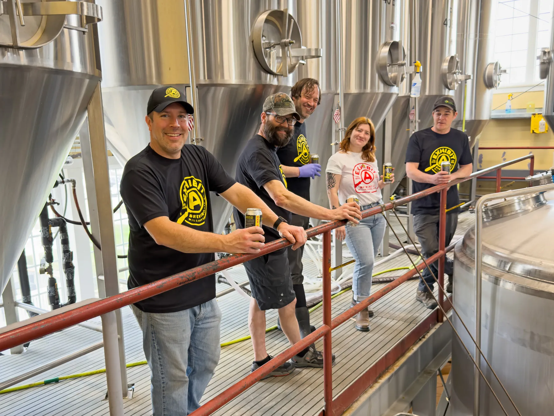 Exhibit A Brewing team in front of beer tanks